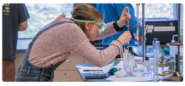 Student wearing goggles working in the chemistry lab